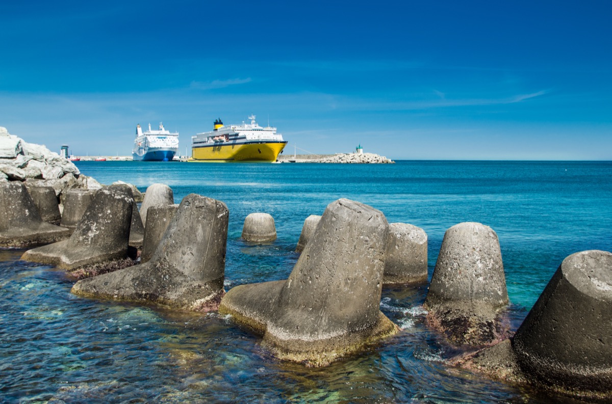 Harbour breakwater at Bastia in Corsica with concrete tetrapods and a ferry