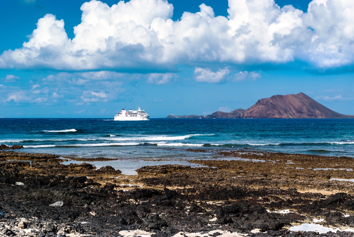 White ferry on the Atlantic off the volcanic coasts of Fuerteventura