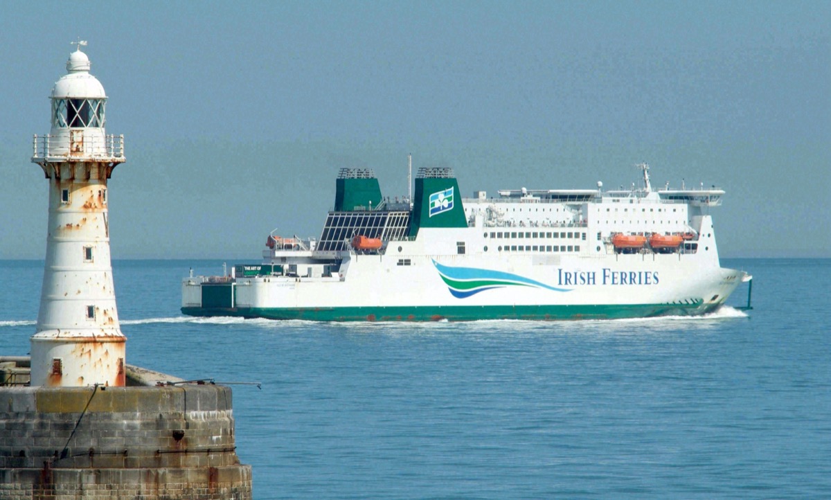 An Irish Ferries ship passes the old lighthouse at the harbor entrance of Dover