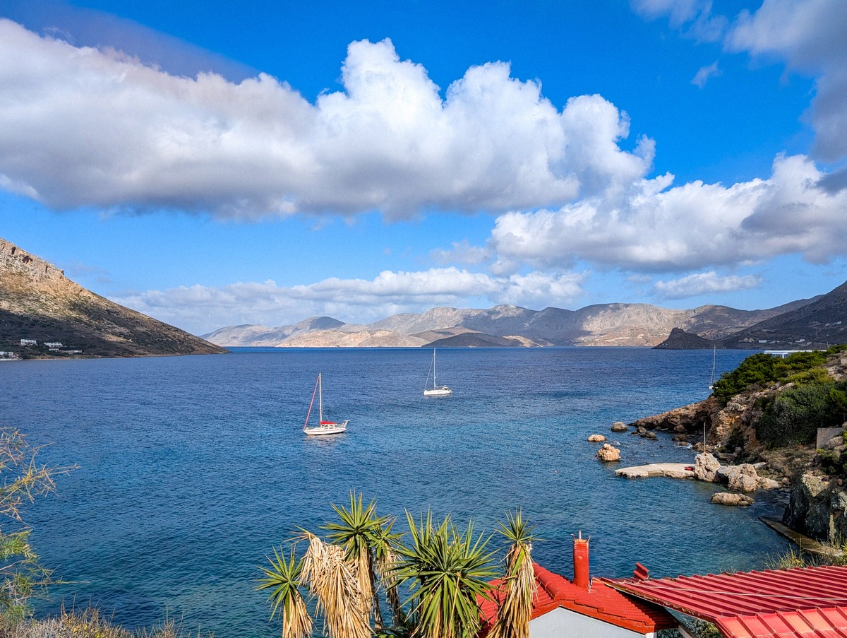 Zwei Segelboote ankern in einer ruhigen Bucht bei Kalymnos, umgeben von schroffen