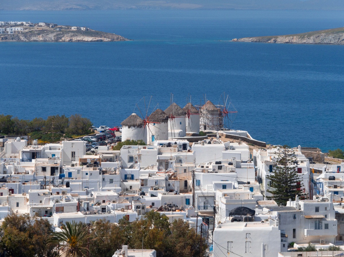 The windmills of Mykonos above the white old town