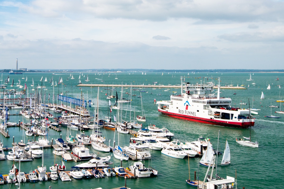 Port of Cowes on the Isle of Wight with sailing boats and a Red Funnel ferry
