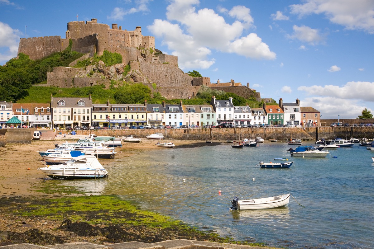 The medieval Mont Orgueil Castle perches on a rock above the fishing harbor of Gorey on Jersey