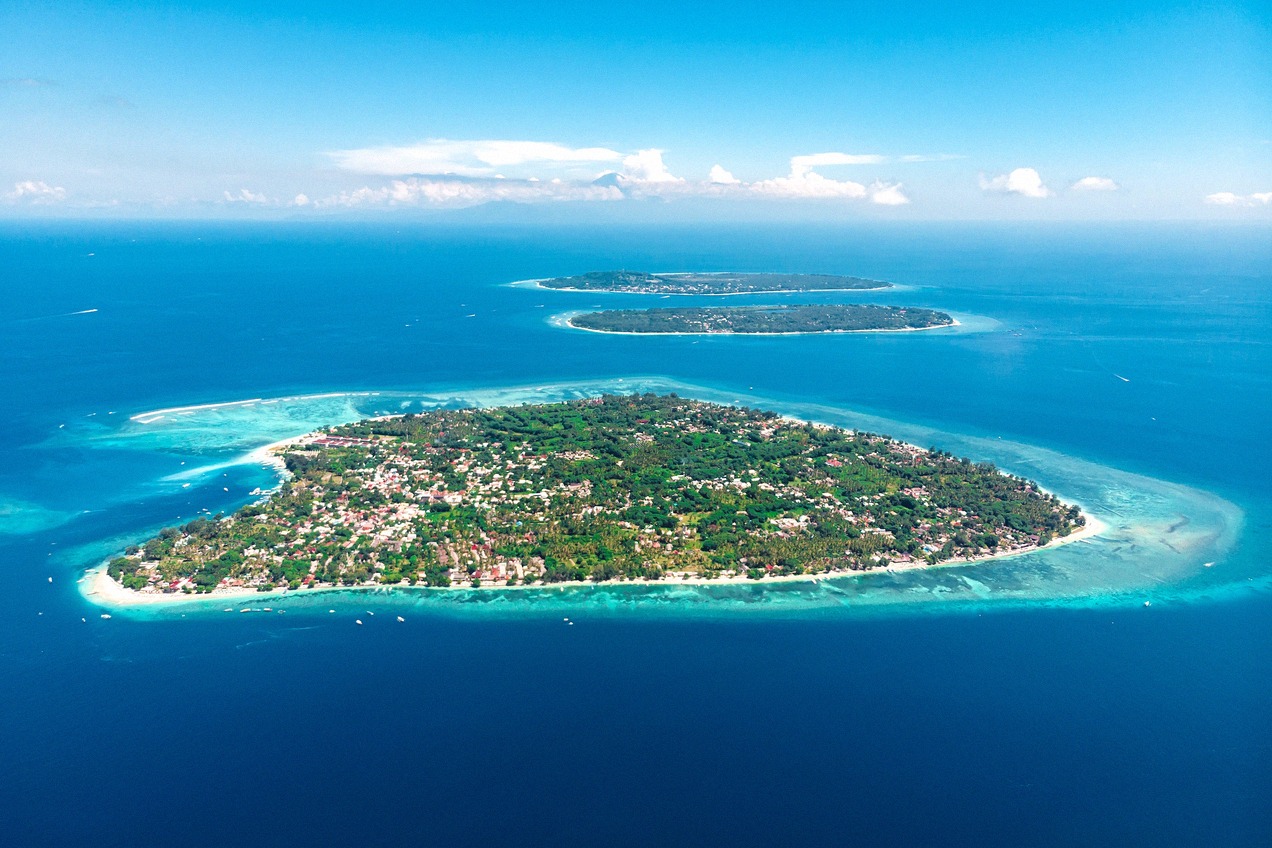 Aerial view of the Gili Islands in the bright blue Indian Ocean