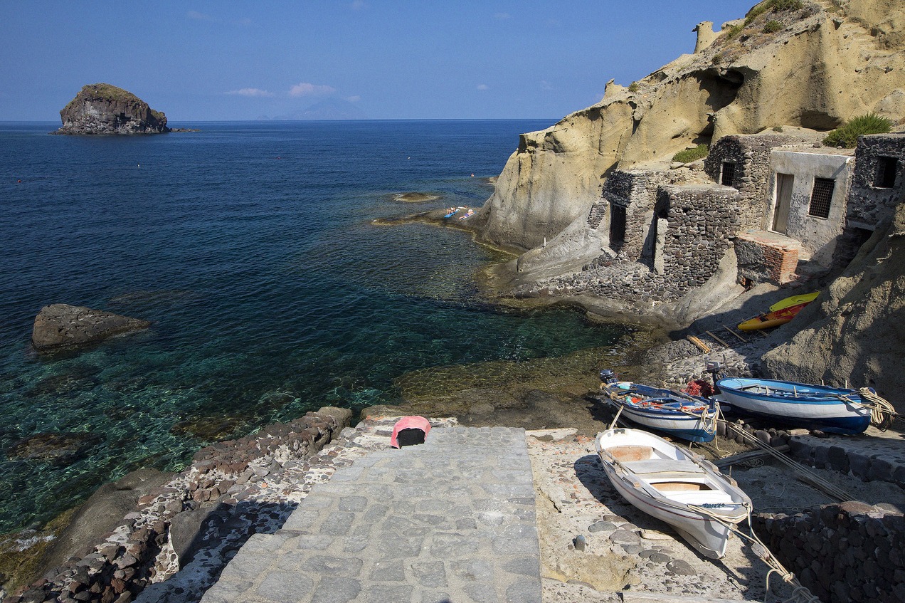 Bay of Pollara on the island of Salina with fishing boats at the stone jetty