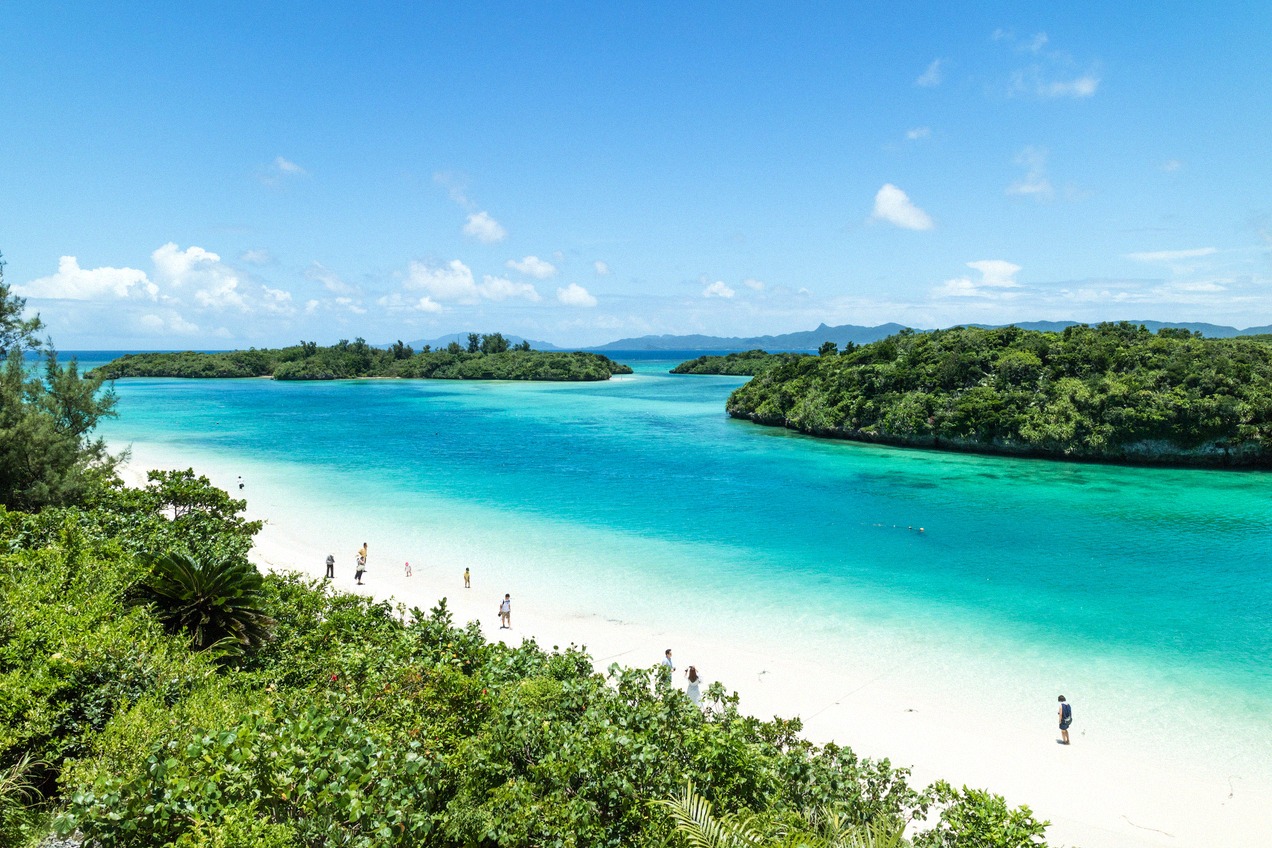 A dreamlike bay with brilliant turquoise water on Ishigaki, framed by wooded islands