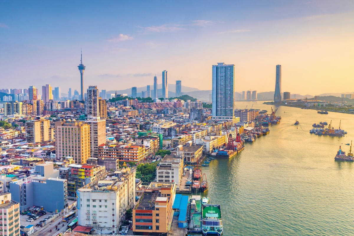 Aerial view of the Macau skyline at sunset with the distinctive Macau Tower