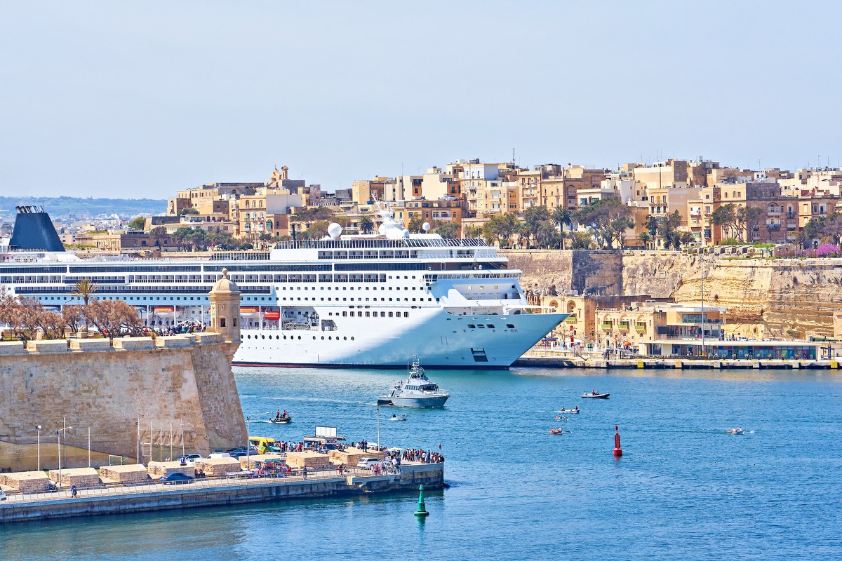 A large cruise ship moored in the Grand Harbour of Valletta