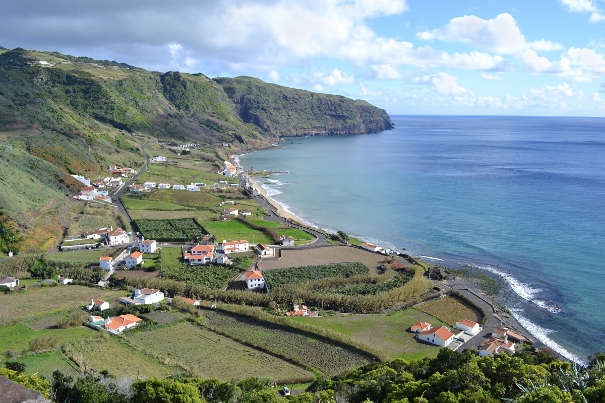 Panoramic view of the coast of Santa Maria with a small village, green fields and the blue Atlantic