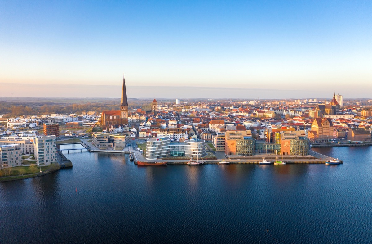 Aerial panorama of Rostock at sunrise, with the church tower of St. Peter's Church
