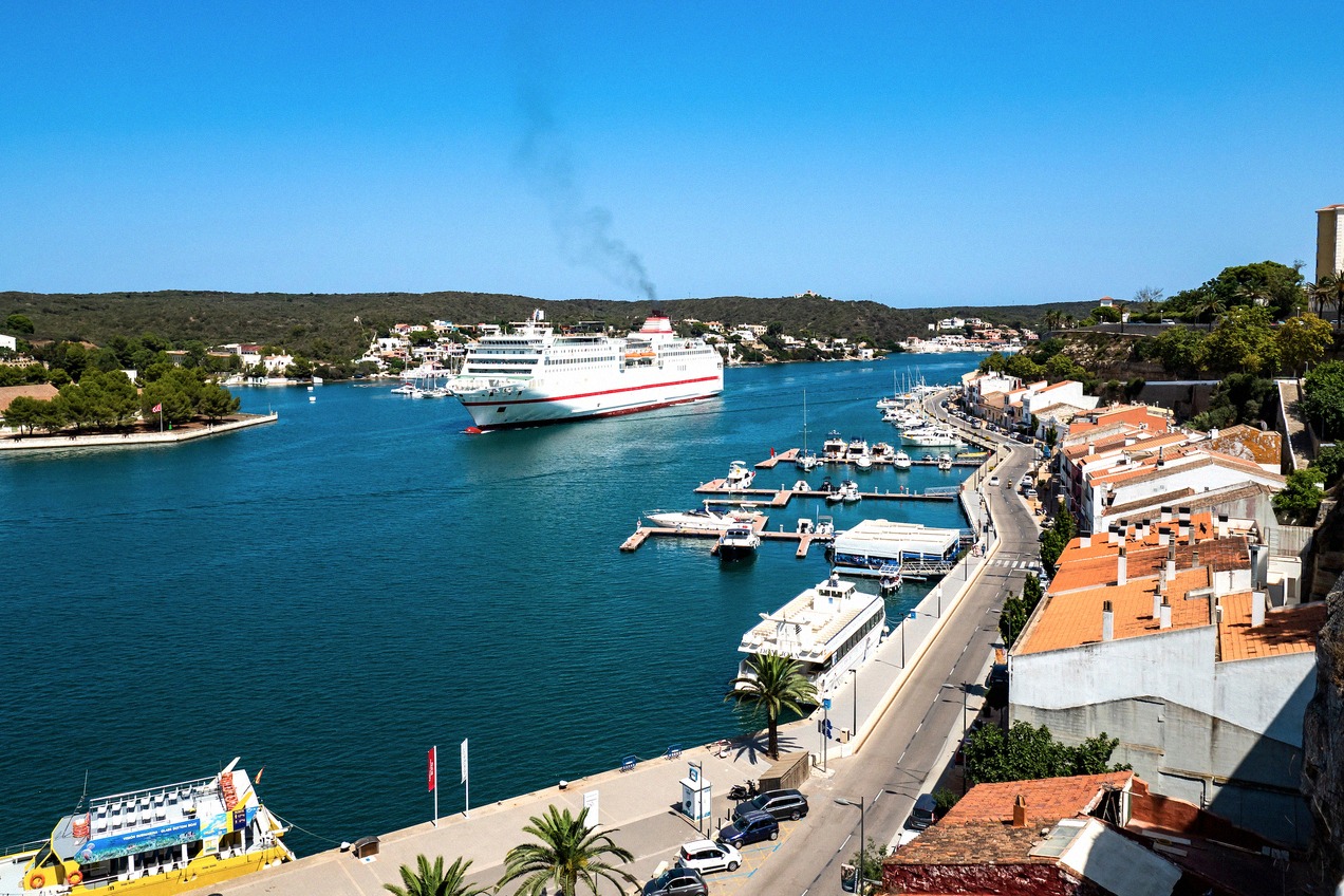 The natural harbour of Mahón on Menorca with a ferry arriving